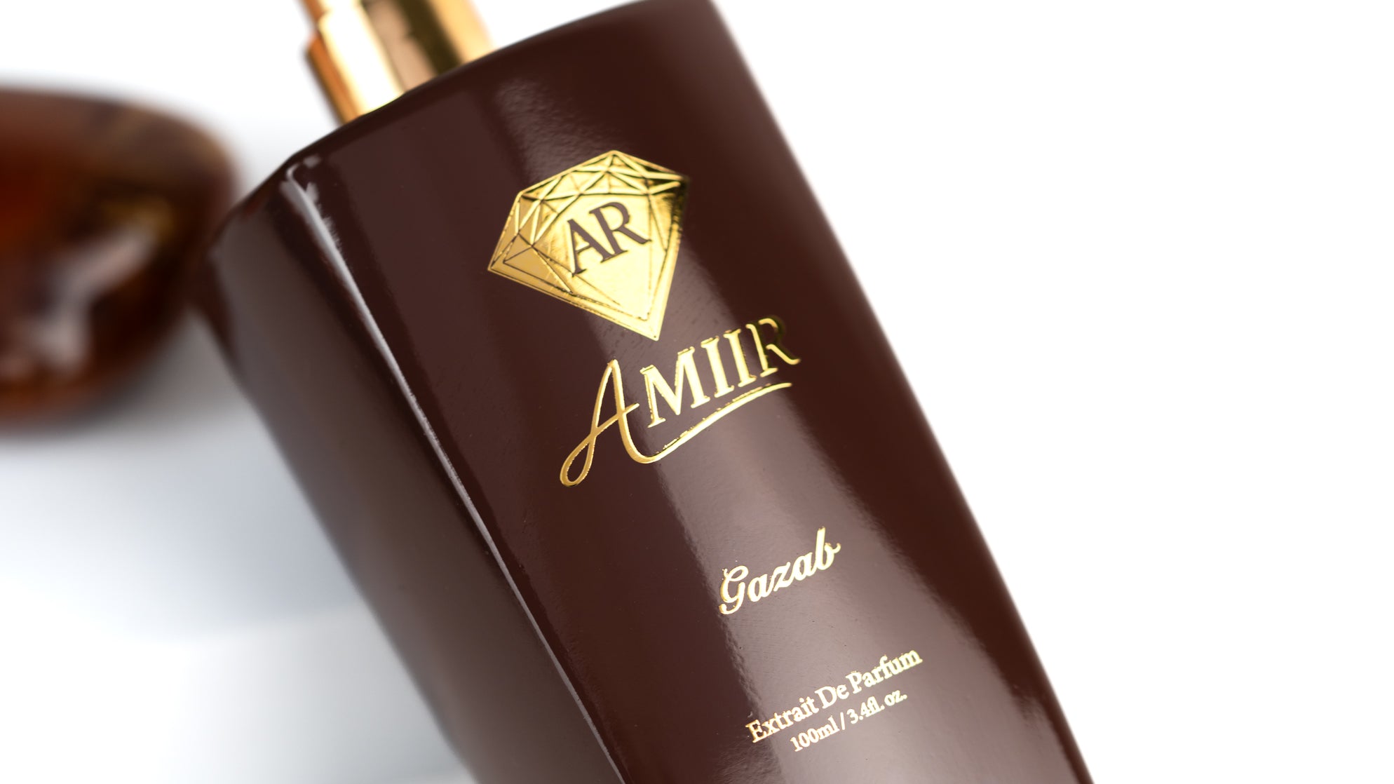 Amiir Scents Gazab perfume bottle with gold cap on a white background with a close up shoot.