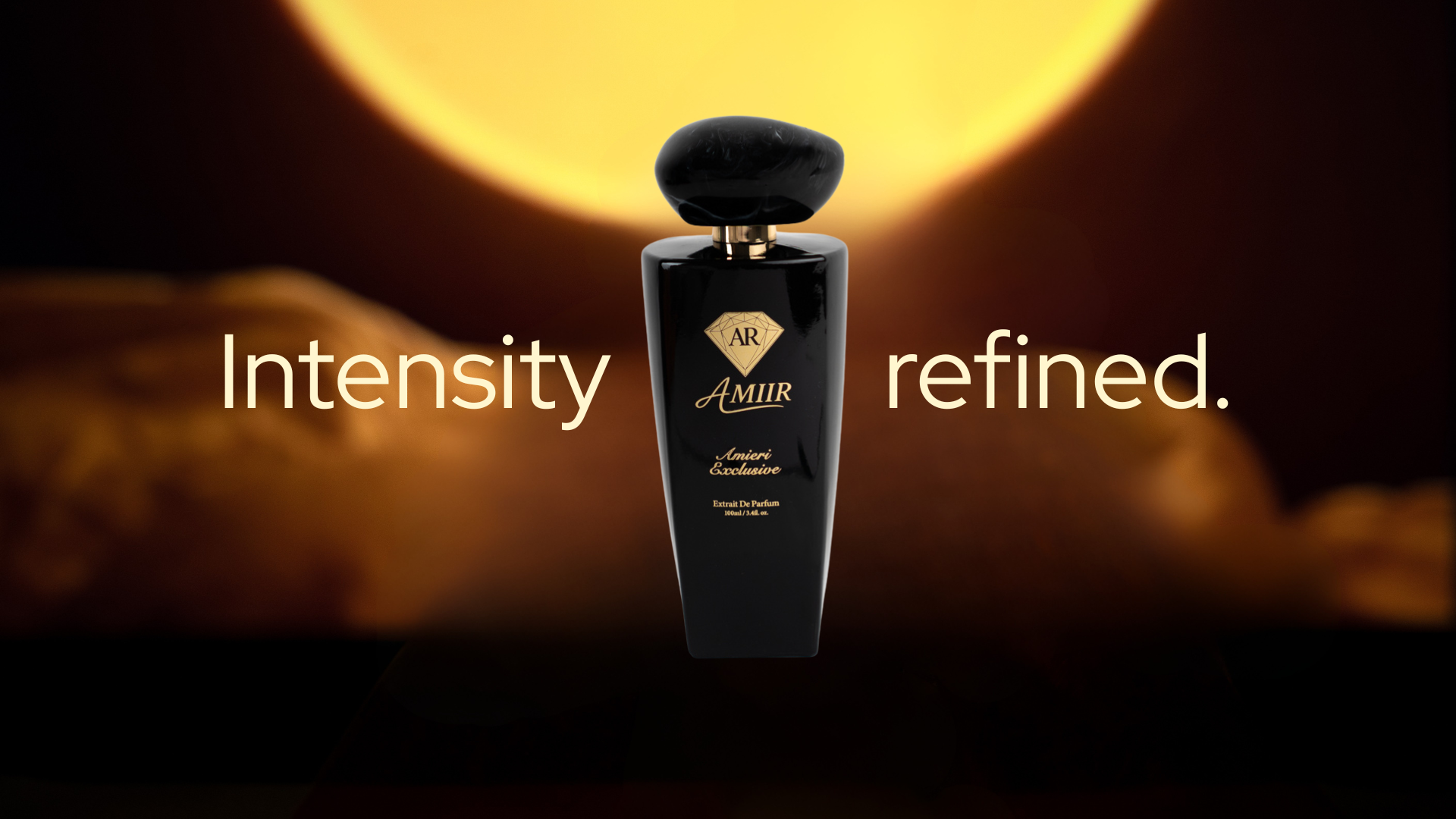 Luxury banner image for AMIIR Amieri Exclusive perfume. The glossy black bottle is centered against a dark, warm background with a large golden moon-like glow behind it. White text on both sides reads “Intensity refined.”, creating a bold and masculine visual composition. The scene uses deep shadows, amber lighting, and strong contrast to communicate elegance, mystery, and a premium men’s fragrance.