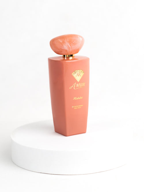 Amiir Scents Habibti extrait de parfum in coral-colored bottle on white background