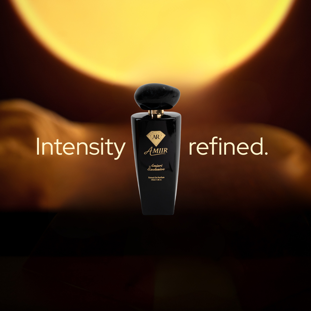 Mobile version of Luxury banner image for AMIIR Amieri Exclusive perfume. The glossy black bottle is centered against a dark, warm background with a large golden moon-like glow behind it. White text on both sides reads “Intensity refined.”, creating a bold and masculine visual composition. The scene uses deep shadows, amber lighting, and strong contrast to communicate elegance, mystery, and a premium men’s fragrance.